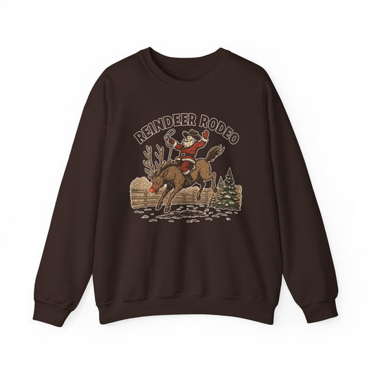 Reindeer Rodeo Crew sweatshirt featuring Santa in cowboy gear on a bucking reindeer, set against a festive western scene. Ideal for cozy holiday wear.