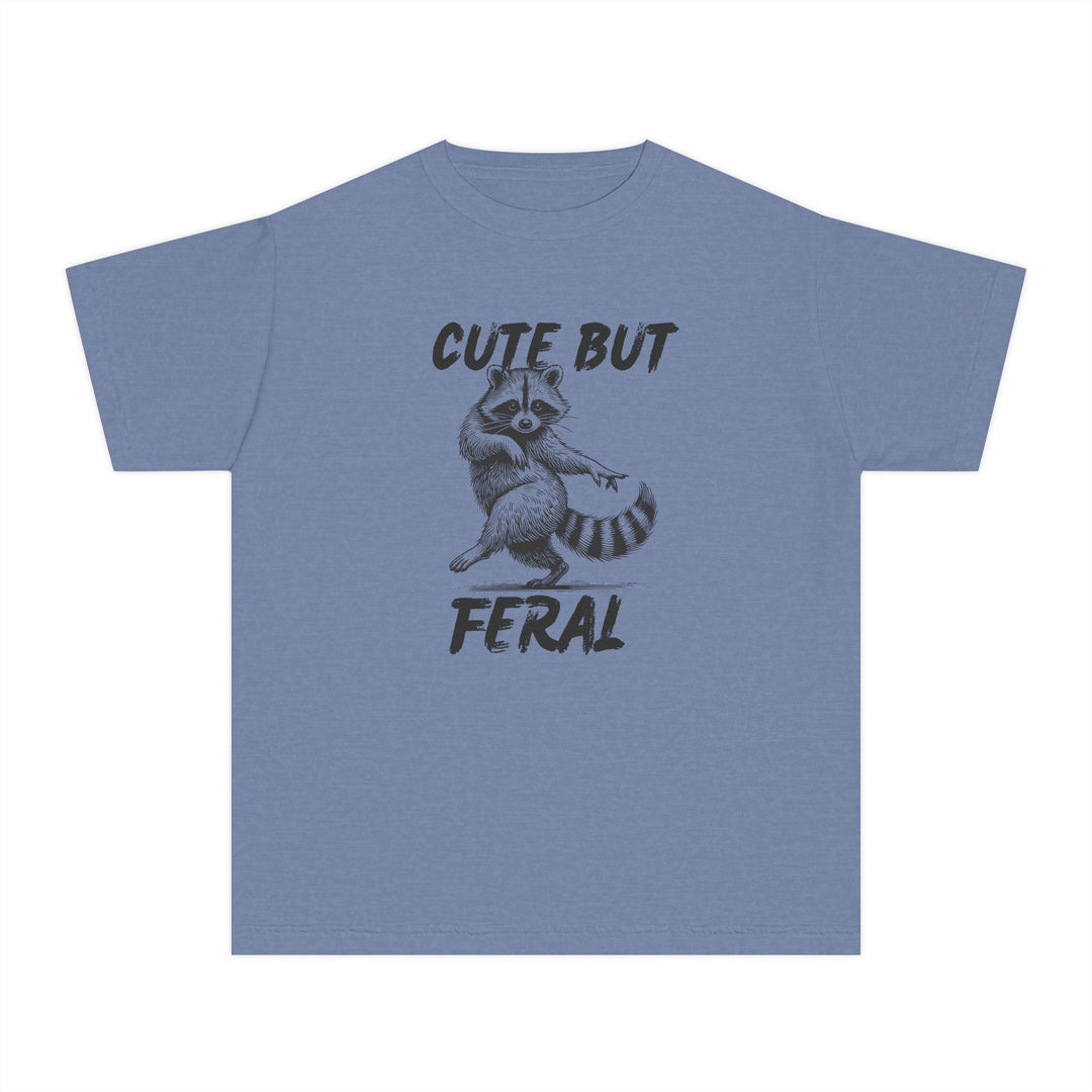 Cute but Feral Kids Tee featuring a playful raccoon illustration and bold text, designed for comfort with 100% combed cotton, ideal for active kids.