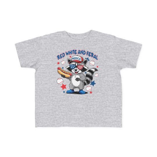 Toddler wearing the Red, White and Feral Baseball 4th Toddler Tee, showcasing its soft, durable cotton fabric, perfect for first adventures.