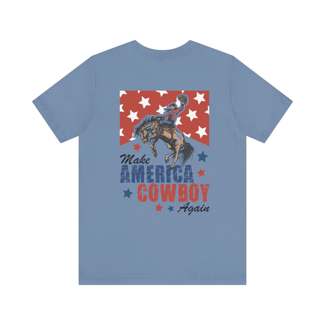 Light-blue Make America Cowboy Again T-shirt with a Western-patriotic design featuring a cowboy on a bronco over stars, ideal for casual, stylish wear.