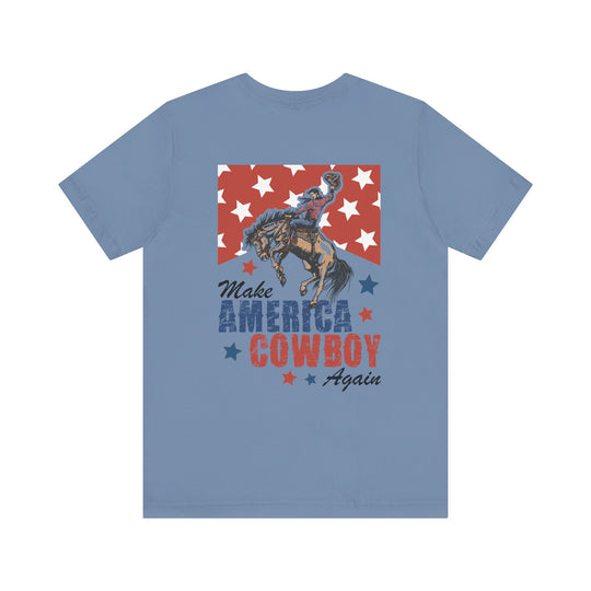 Light-blue Make America Cowboy Again T-shirt with a Western-patriotic design featuring a cowboy on a bronco over stars, ideal for casual, stylish wear.