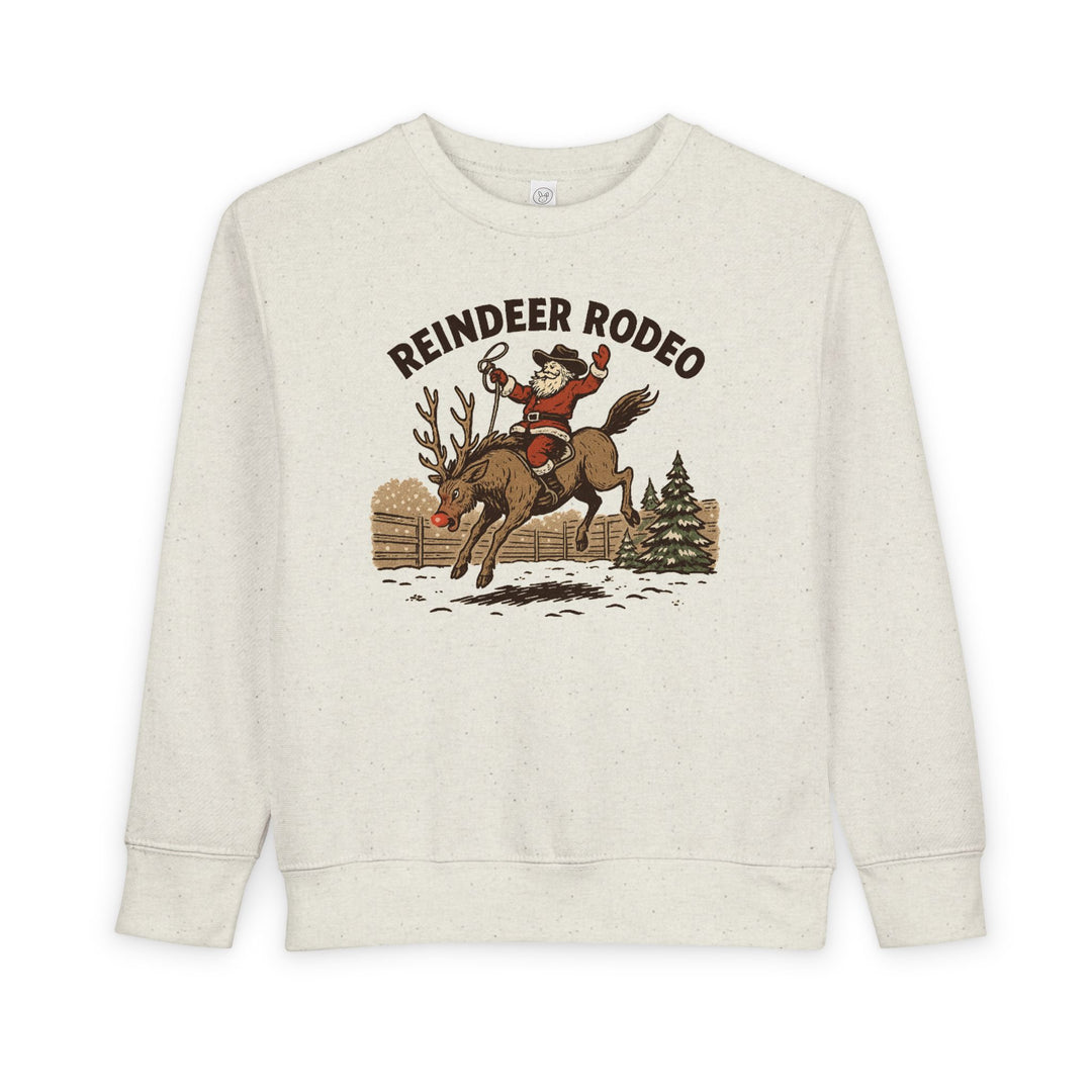 Reindeer Toddler Crew: Light-cream sweatshirt featuring Santa in cowboy attire riding a reindeer, perfect for keeping toddlers warm and stylish during festive seasons.