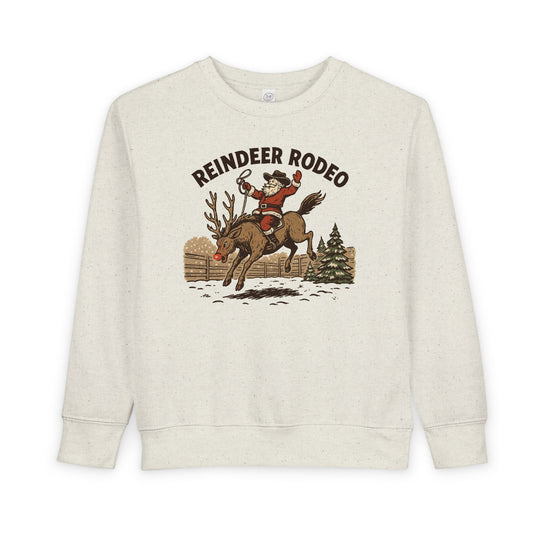Reindeer Toddler Crew: Light-cream sweatshirt featuring Santa in cowboy attire riding a reindeer, perfect for keeping toddlers warm and stylish during festive seasons.