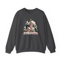 Gift is Jesus Crew sweatshirt with festive winter scene, pink church, snow-laden trees, and The Greatest Gift Is JESUS phrase in script on charcoal-gray fabric.