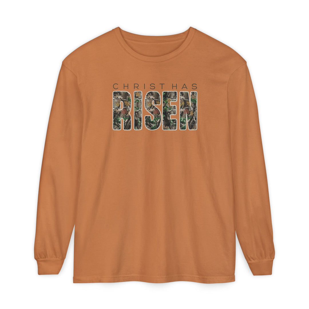 Burnt-orange T-shirt displaying CHRIST HAS RISEN with a woodland-patterned design, crafted from 100% ring-spun cotton for comfort and style in a relaxed fit.
