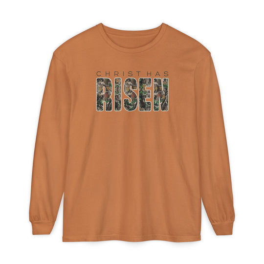 Burnt-orange T-shirt displaying CHRIST HAS RISEN with a woodland-patterned design, crafted from 100% ring-spun cotton for comfort and style in a relaxed fit.