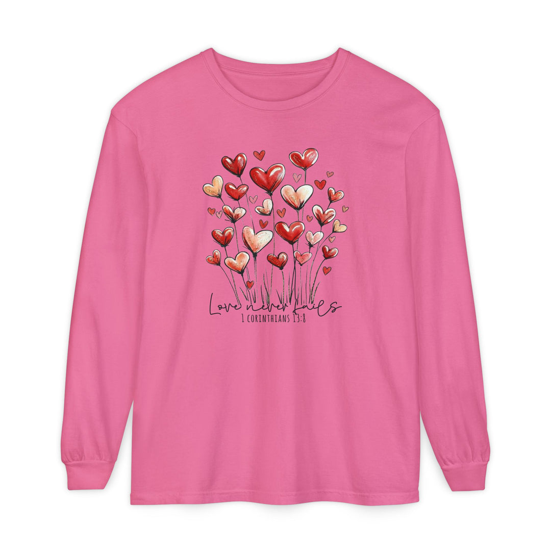 Love Never Fails Long Sleeve Tee featuring heart-shaped blooms and 1 Corinthians 13:8 text, made of soft, garment-dyed 100% ring-spun cotton.