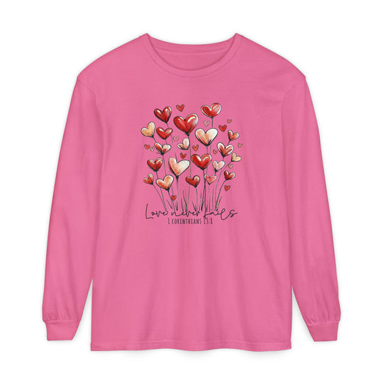 Love Never Fails Long Sleeve Tee featuring heart-shaped blooms and 1 Corinthians 13:8 text, made of soft, garment-dyed 100% ring-spun cotton.