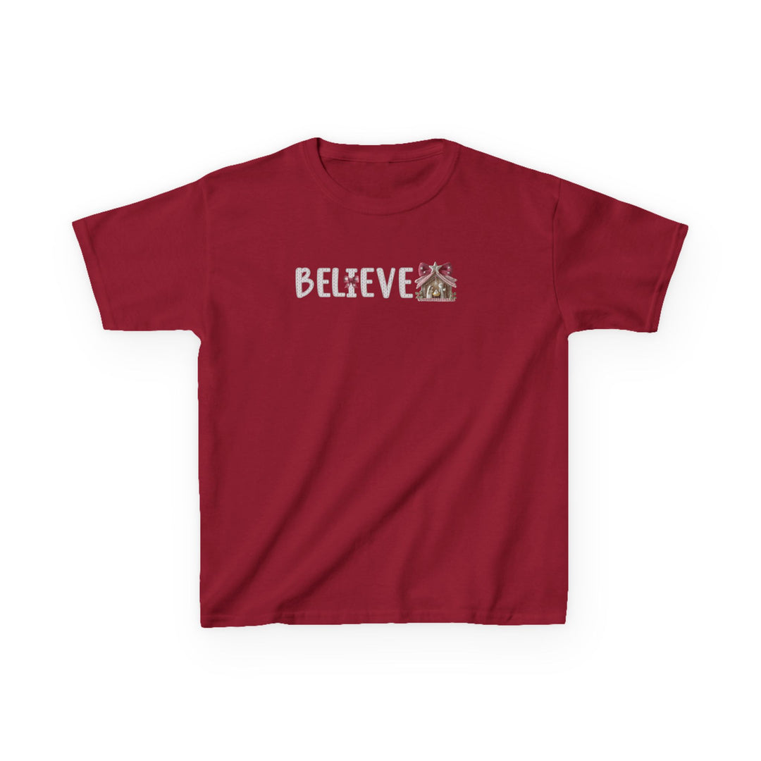 Kids' Believe Tee: Red short-sleeve T-shirt with BELIEVE in Christmas/gingerbread style, featuring frosted cookie letters and gingerbread motifs, perfect for everyday wear.
