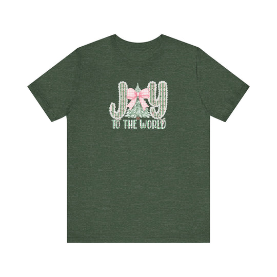 Joy to the World Tee: Festive dark-green T-shirt featuring JOY with cacti and pine tree graphic, pink gingham bow, and TO THE WORLD lettering. Classic fit, soft cotton.