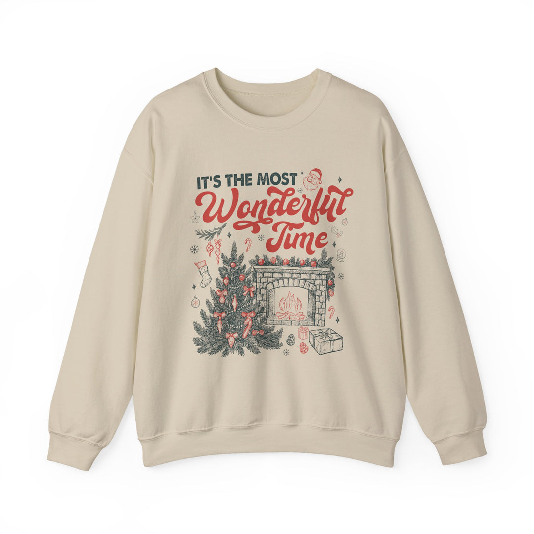 Cream-colored crewneck sweatshirt with festive It's the most Wonderful Time Christmas graphic featuring a tree, fireplace, and holiday motifs.
