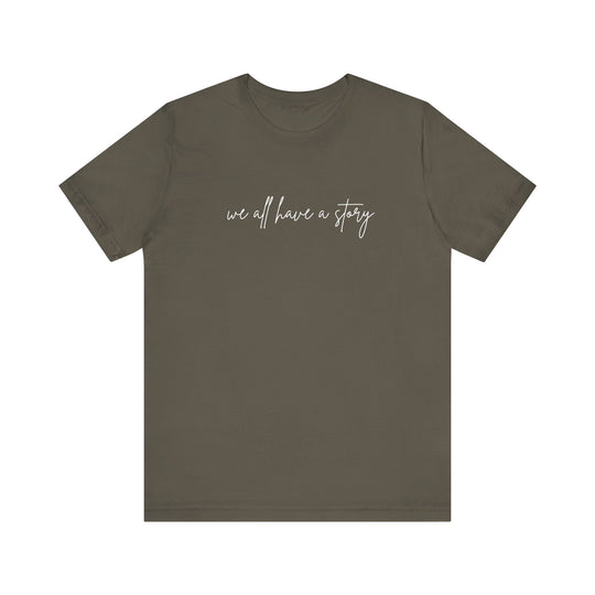We all have a Story Tee, featuring white text on a grey t-shirt, perfect for casual wear with soft cotton and a comfortable fit.