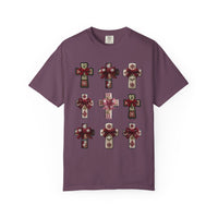 Crosses Tee featuring a 3×3 grid of decorative, snowflake-adorned crosses with bows, on a purple background, highlighting unique style and luxurious comfort.