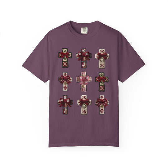 Crosses Tee featuring a 3×3 grid of decorative, snowflake-adorned crosses with bows, on a purple background, highlighting unique style and luxurious comfort.