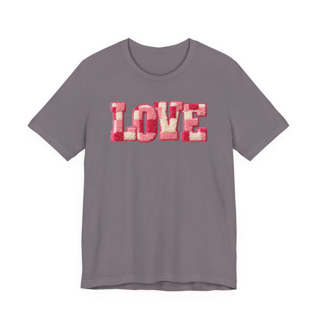 Love Tee with tufted LOVE text in pink hues on a muted grayish-purple short-sleeve shirt, showcasing a soft, classic fit from Faith Family Designs.