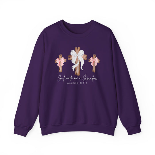 Purple crewneck sweatshirt with three wooden crosses, white and pink bows, and God Made Me a Grandma text. Comfortable, unisex fit from Faith Family Designs.