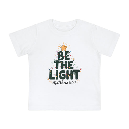 Be the Light Baby Tee: White kids' T-shirt with a festive Christmas tree design, featuring 'BE THE LIGHT', colorful lights, and 'Matthew 5:14' reference.