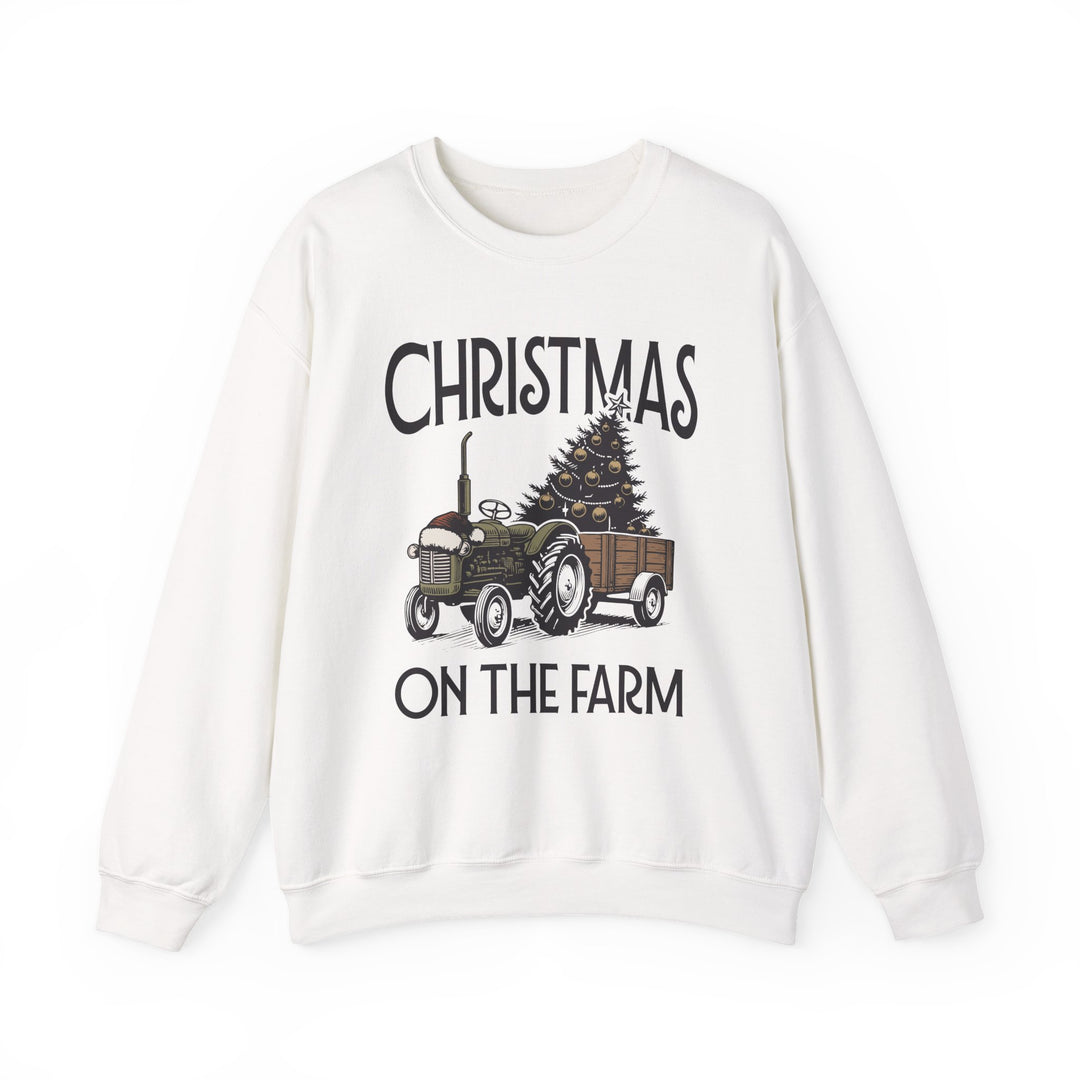 White sweatshirt featuring Christmas on the Farm design with a green tractor towing a decorated Christmas tree, ideal for cozy, festive wear.