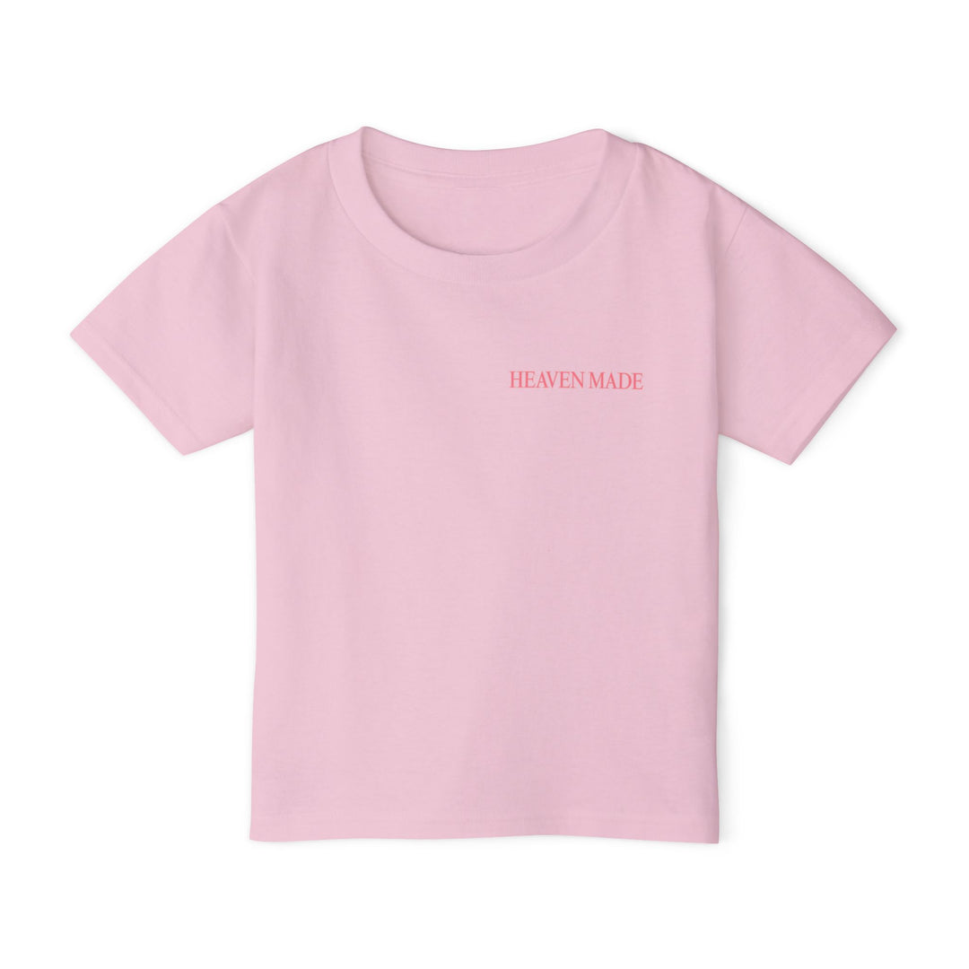 Heavy Cotton™ Toddler T-shirt featuring HEAVEN MADE text on light-pink fabric; designed for eco-friendly comfort and style with 100% cotton material.