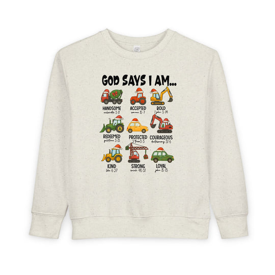 God Says Christmas Truck Toddler Crew sweatshirt featuring cartoon vehicles with Santa hats and uplifting adjectives, designed for warmth and comfort in a soft fleece blend.