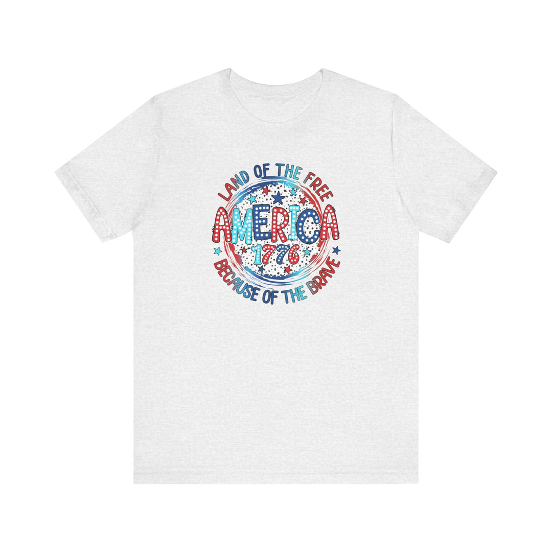 A classic America 1776 Tee, white with red and blue text, in a soft cotton jersey. Unisex fit with ribbed collars, taping on shoulders, and tear-away label. Retail fit, 100% Airlume combed cotton.