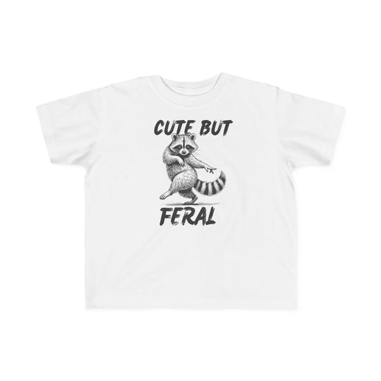 Cute but Feral Toddler Tee featuring a playful hand-drawn raccoon illustration with brush-stroke text, designed for toddlers with soft, durable cotton fabric.