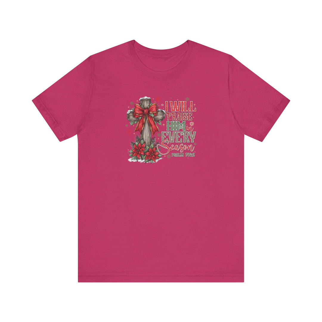 Praise Him in Every Season Tee featuring a rustic cross graphic with poinsettias and Psalm 146:2 text on a bright pink background. Classic fit, soft cotton.