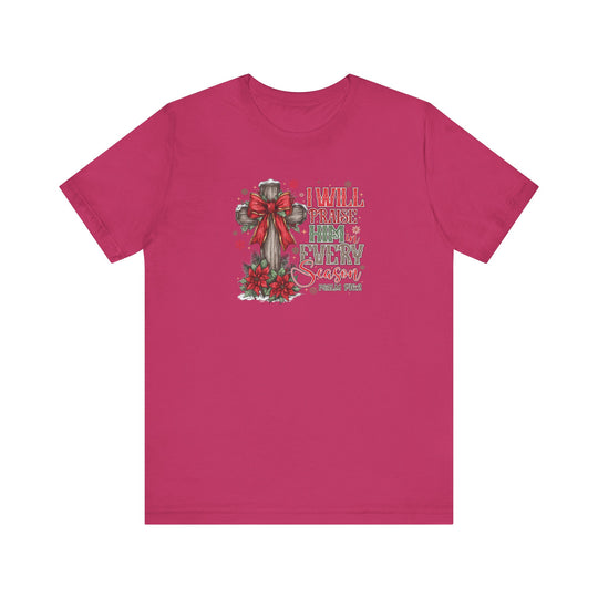 Praise Him in Every Season Tee featuring a rustic cross graphic with poinsettias and Psalm 146:2 text on a bright pink background. Classic fit, soft cotton.