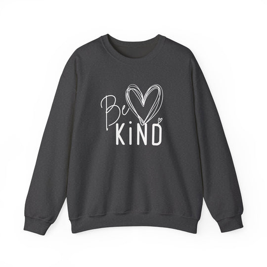 Dark-charcoal crewneck sweatshirt with Be Kind graphic, featuring a handwritten script and block letters, accented by sketched hearts. Unisex, cozy, and durable.