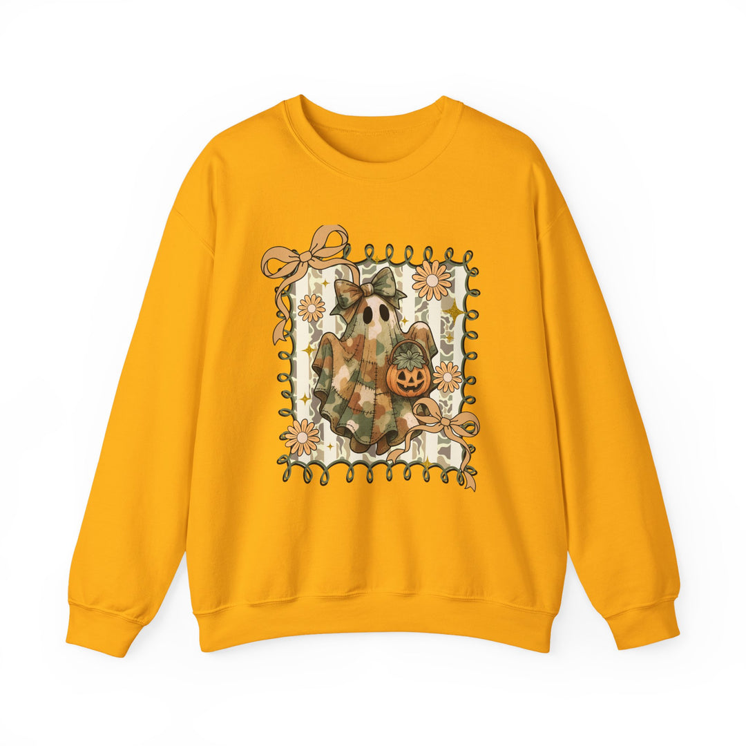 Quilted Ghost Crew: Mustard-yellow sweatshirt with whimsical ghost graphic, camo-style sheet, bow, jack-o’-lantern bucket, framed by ribbons and daisies. Cozy, durable, unisex fit.