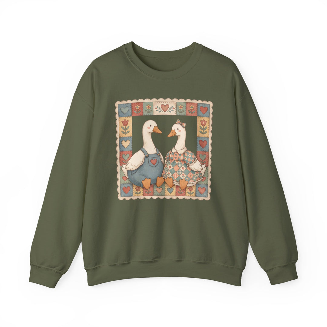 Thrifted Geese Crew sweatshirt features folk-art style waterfowl in charming attire, framed by hearts and flowers, offering comfort with a ribbed collar and seamless design.