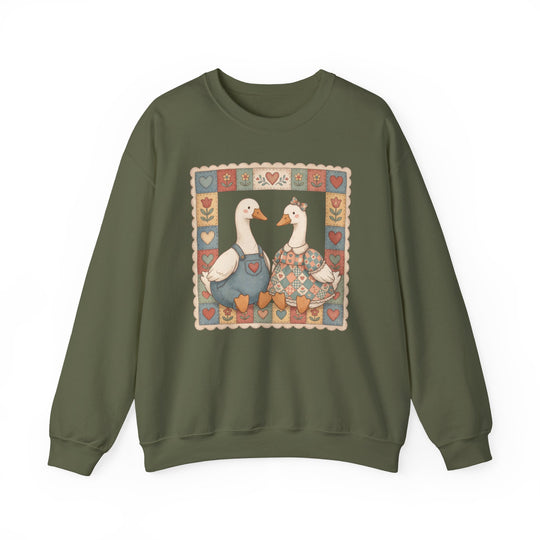 Thrifted Geese Crew sweatshirt features folk-art style waterfowl in charming attire, framed by hearts and flowers, offering comfort with a ribbed collar and seamless design.