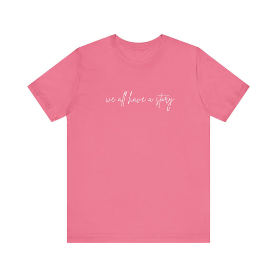 We all have a Story Tee: Pink unisex jersey short sleeve t-shirt featuring white text, perfect for casual wear and showcasing a soft, comfortable fit.