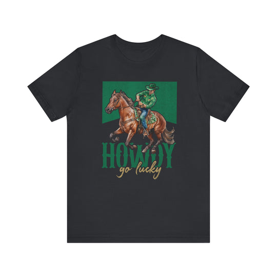 Howdy Go Lucky Tee featuring a cowboy riding a horse. This unisex jersey short sleeve t-shirt offers a soft, comfortable fit with durable shaping.