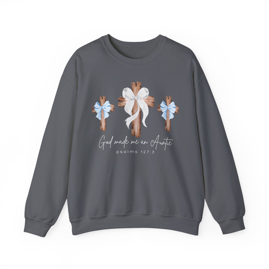 Charcoal-gray sweatshirt featuring three wooden crosses with bows and God Made Me an Auntie text, emphasizing comfort and quality with a polyester-cotton blend.