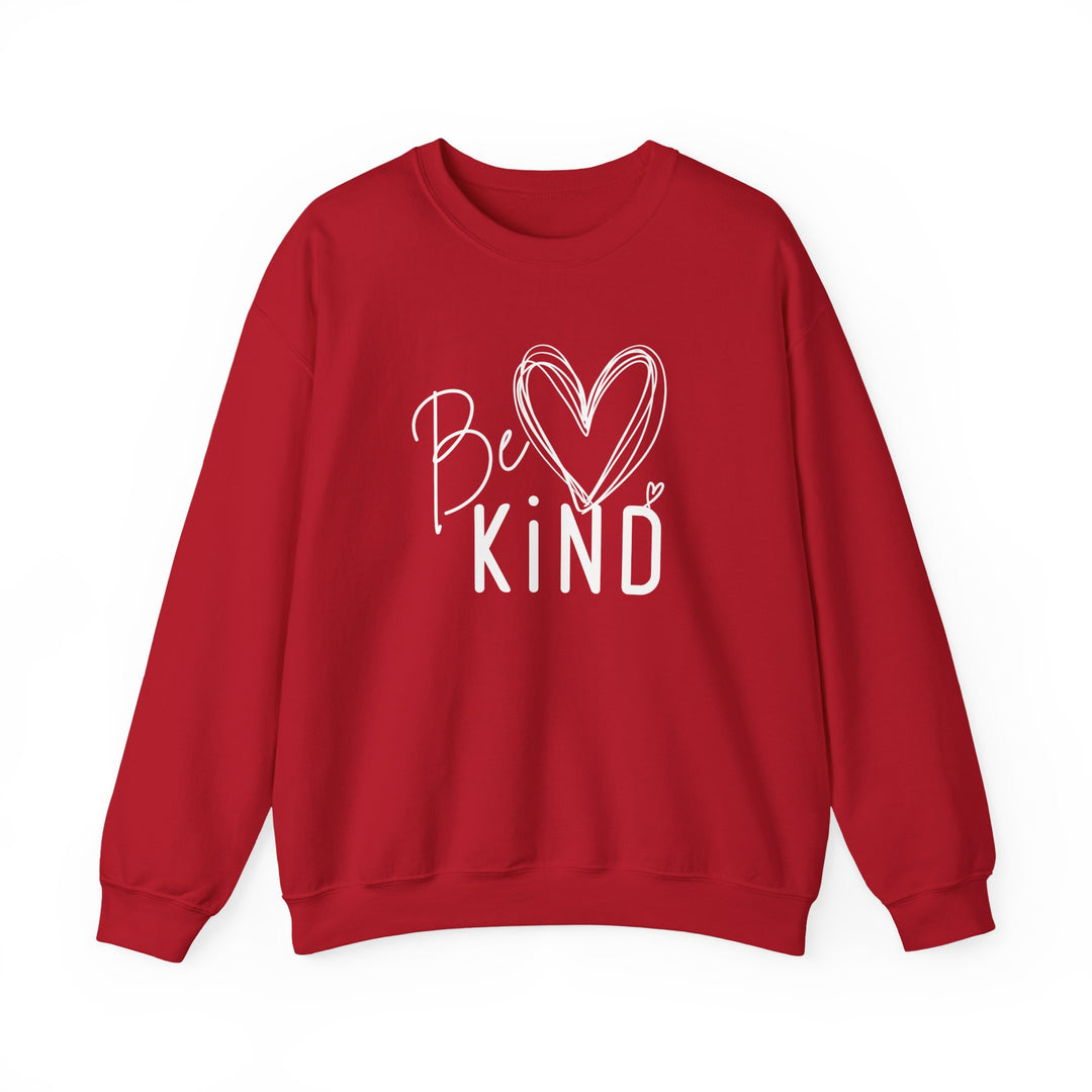 Red crewneck sweatshirt with Be Kind in white hand-drawn graphic featuring a heart, highlighting comfort and ethical production. Ideal for colder months.