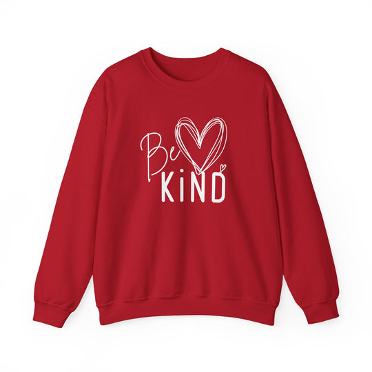 Red crewneck sweatshirt with Be Kind in white hand-drawn graphic featuring a heart, highlighting comfort and ethical production. Ideal for colder months.