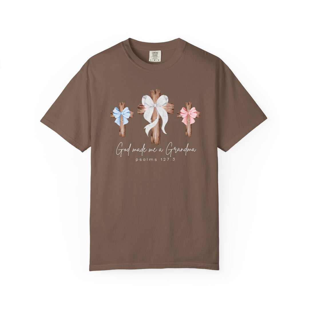 Brown “God Made Me a Girl - Boy Grandma Tee” featuring three rustic crosses with bows and scripture, designed for comfort with a relaxed fit.