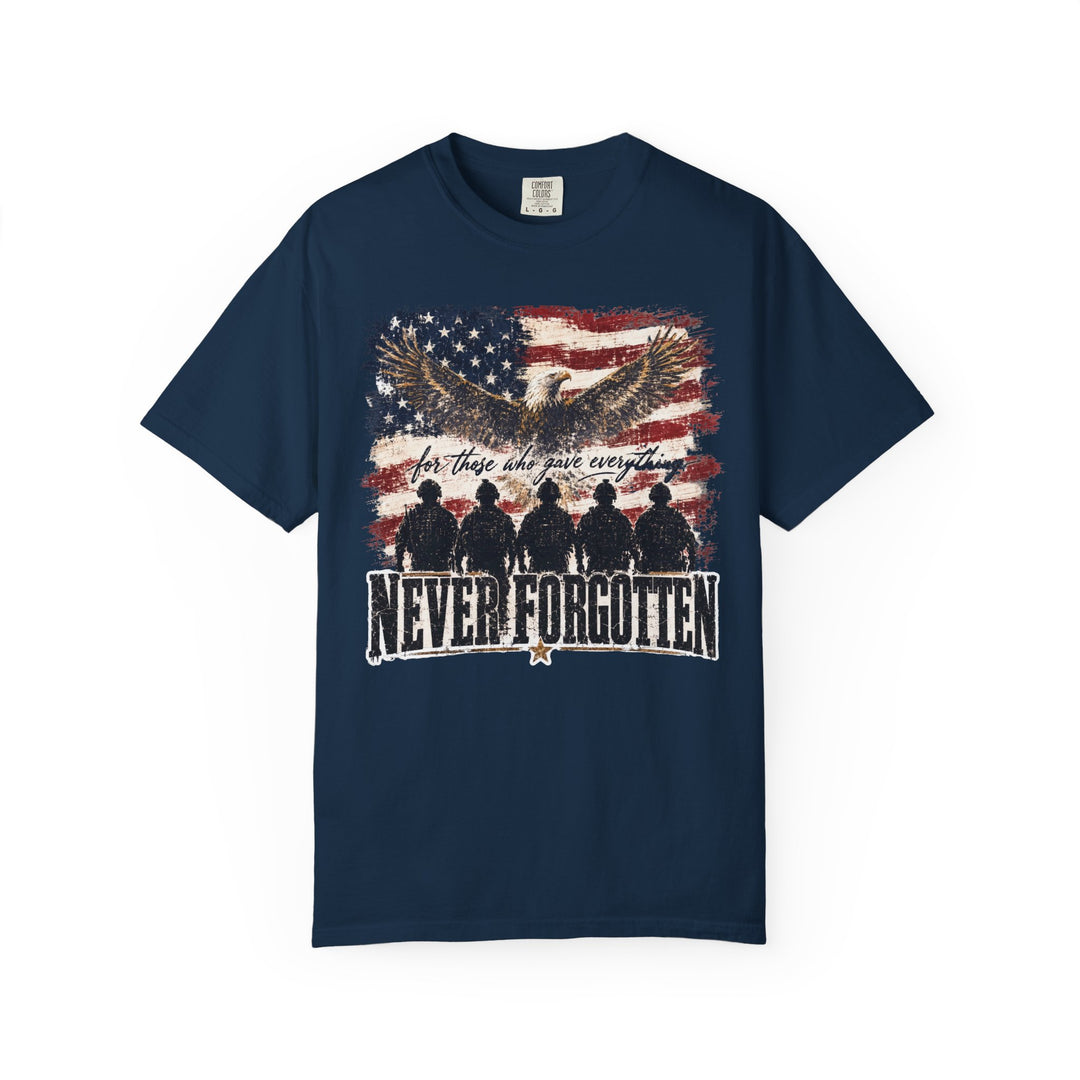 Never Forgotten Tee: Navy-blue shirt featuring a bald eagle, distressed American flag, soldier silhouettes, and “NEVER FORGOTTEN” slogan, embodying tribute and remembrance.
