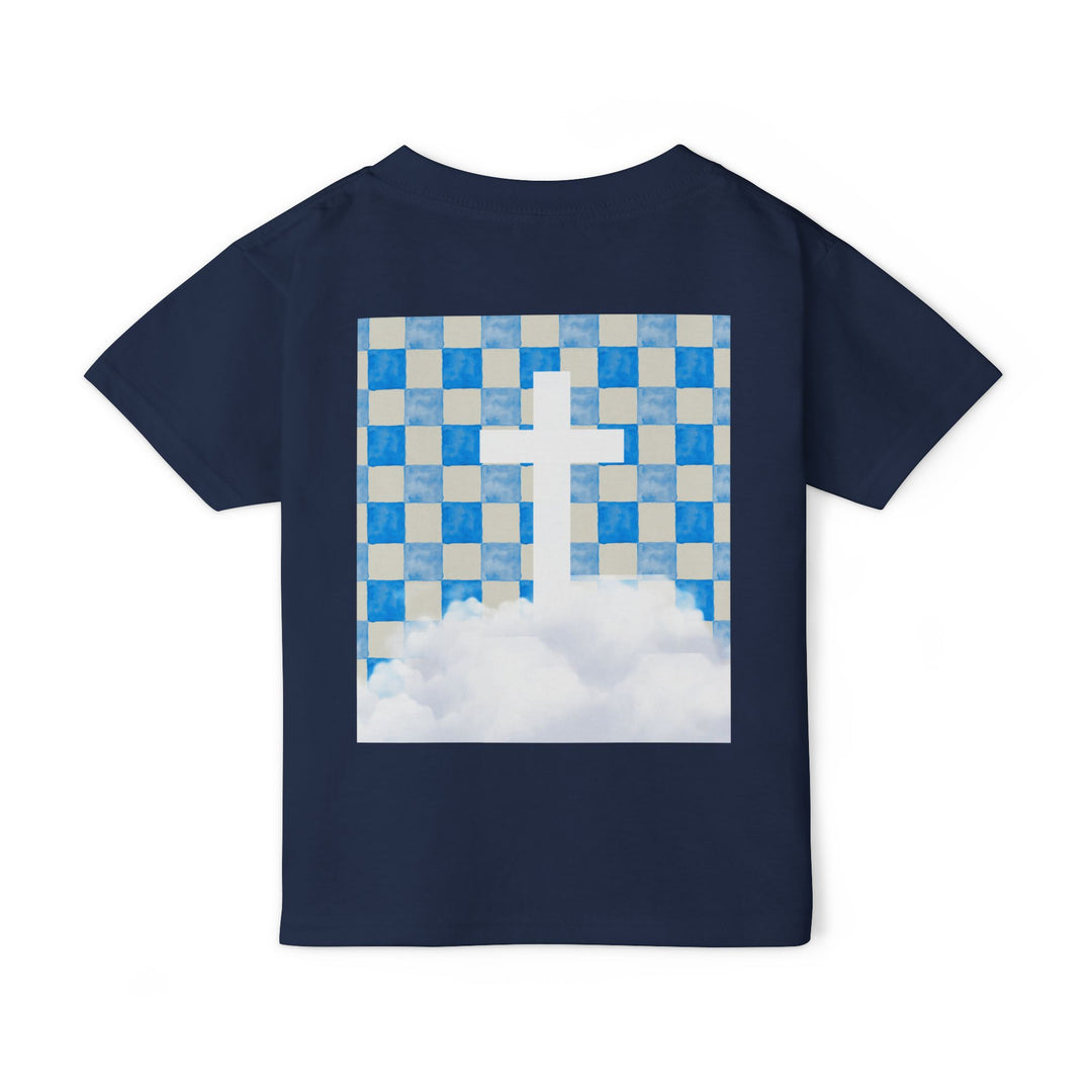 Heavy Cotton™ Toddler T-shirt's back showcases a navy-blue fabric with a graphic of a cross emerging from clouds under a checkerboard sky, emphasizing comfort and style.
