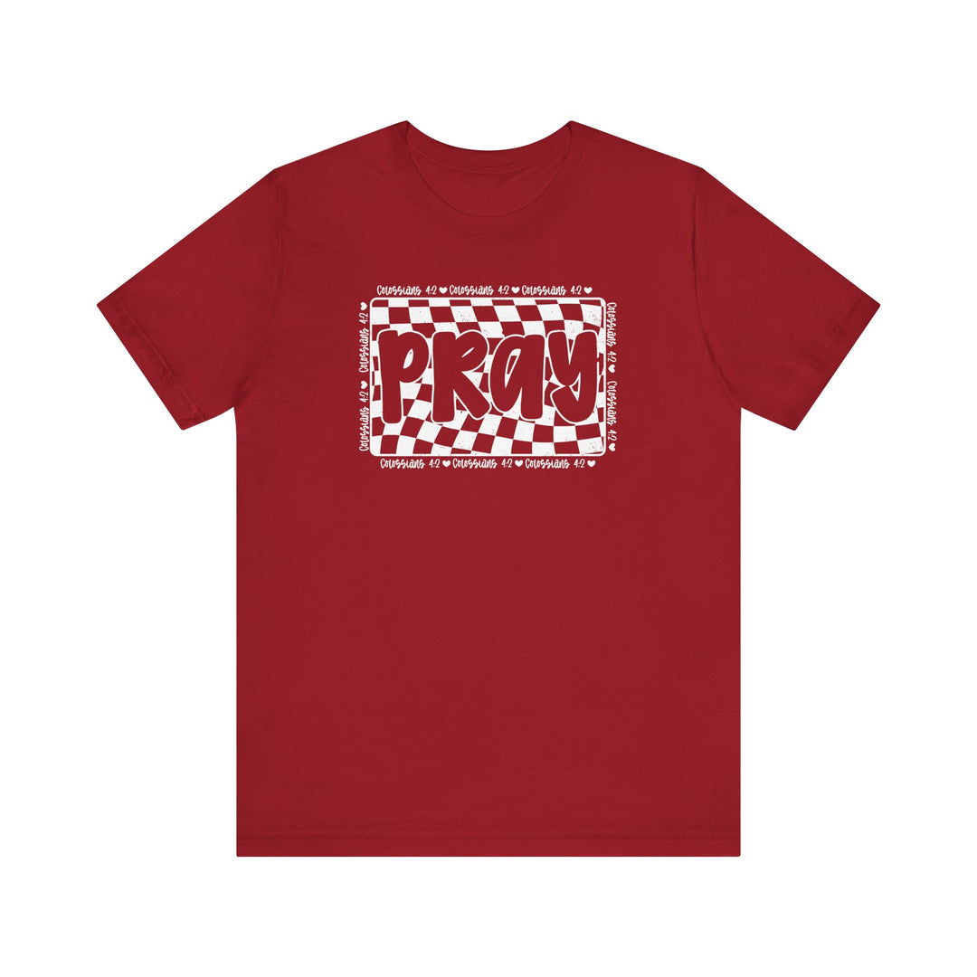 Pray Tee: Red t-shirt featuring bold white text, designed for comfort with soft cotton, ribbed collar, and dual side seams for durability.