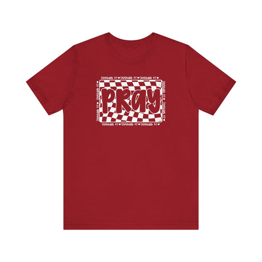 Pray Tee: Red t-shirt featuring bold white text, designed for comfort with soft cotton, ribbed collar, and dual side seams for durability.