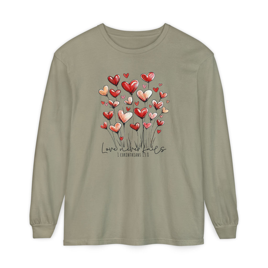 Love Never Fails Long Sleeve Tee features heart-topped flower stems and script text on a muted olive cotton shirt, offering comfort and style.