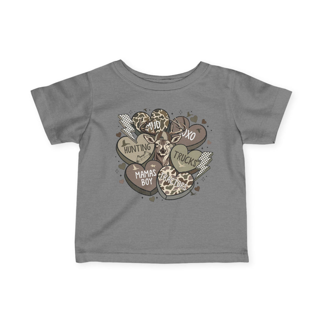 Boy Valentine Baby Tee featuring a stylized deer head with heart and lightning motifs, showcasing words like Mama’s Boy and Dad on a grey T-shirt.