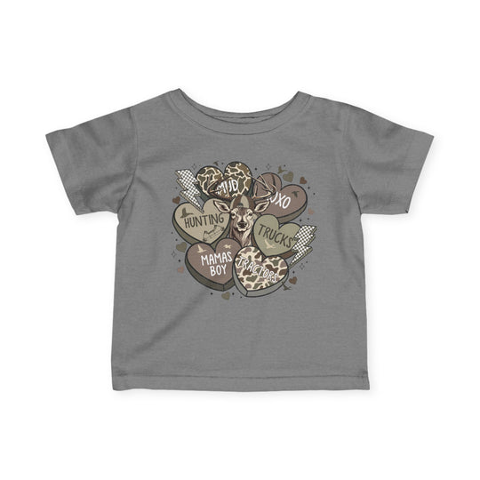 Boy Valentine Baby Tee featuring a stylized deer head with heart and lightning motifs, showcasing words like Mama’s Boy and Dad on a grey T-shirt.