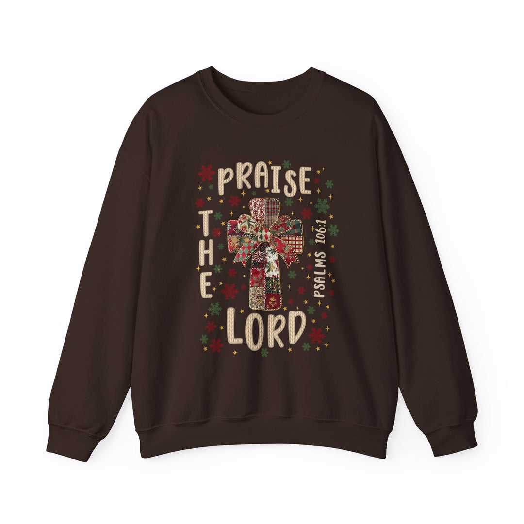Praise the Lord Crew sweatshirt features a patchwork cross with a bow, surrounded by festive designs and scripture, offering cozy comfort with ethical craftsmanship.