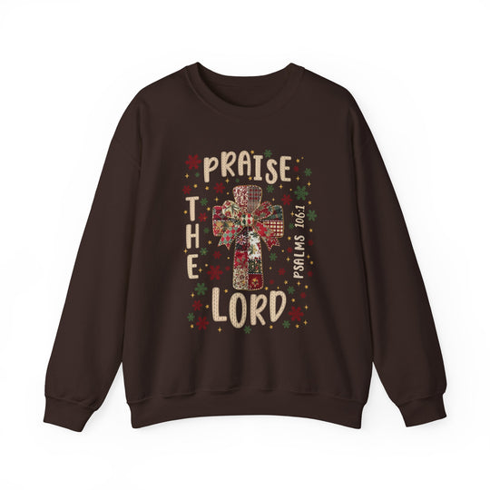 Praise the Lord Crew sweatshirt features a patchwork cross with a bow, surrounded by festive designs and scripture, offering cozy comfort with ethical craftsmanship.