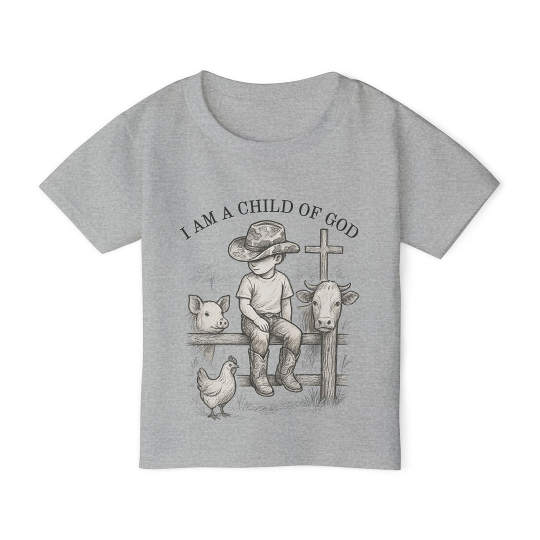 Toddler wearing I Am a Child of God tee, featuring a child with farm animals and a cross, showcasing rustic charm and spiritual message.
