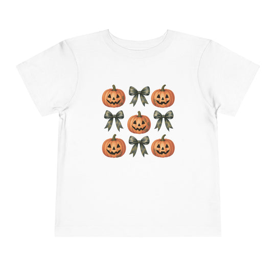 Pumpkins and Bows Toddler Tee featuring a 3×3 grid of jack-o’-lanterns and ribbon bows, perfect for Halloween-themed, comfortable wear. Made of 100% Airlume cotton.