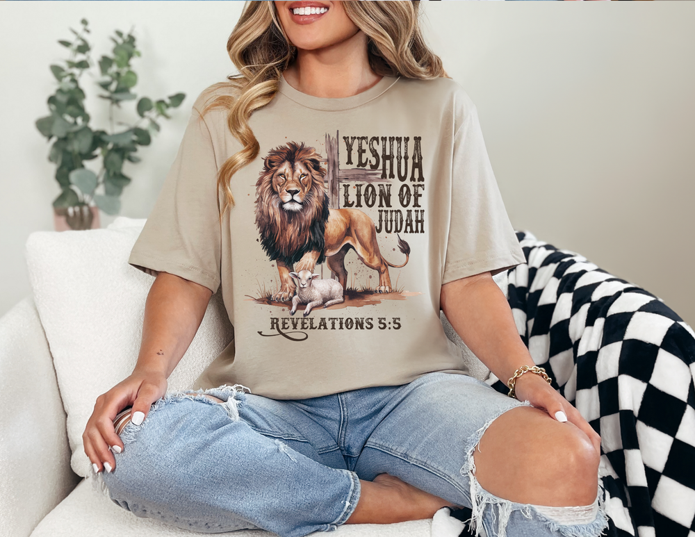 Woman wearing the Yeshua Lion of Judah Tee, a classic unisex jersey short sleeve shirt, sitting on a couch, showcasing a comfortable and stylish fit.